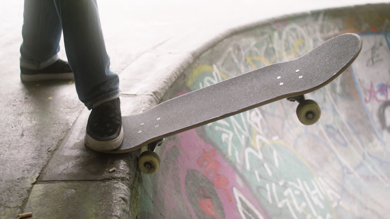 Boy's feet on skateboard in the park.