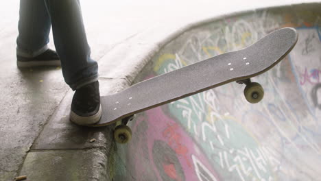 boy's feet on skateboard in the park.