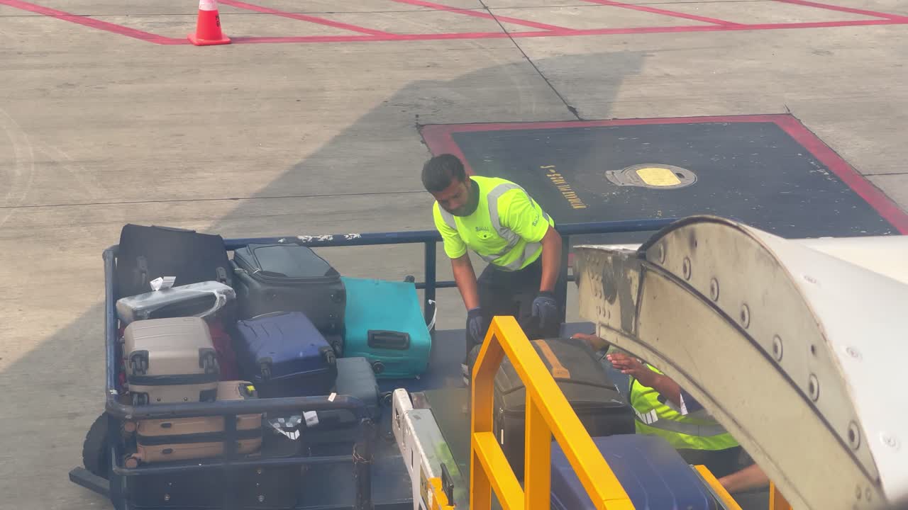 Airport workers efficiently handling and organizing luggage on the tarmac. Ensuring smooth and timely loading onto the aircraft. Showcasing teamwork and coordination essential for airport operations