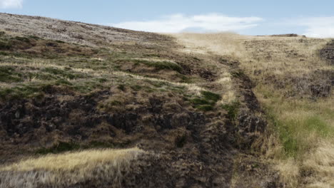 Lowering-aerial-revealing-dried-up-waterfall-from-cliffs-at-tabletop-mountain