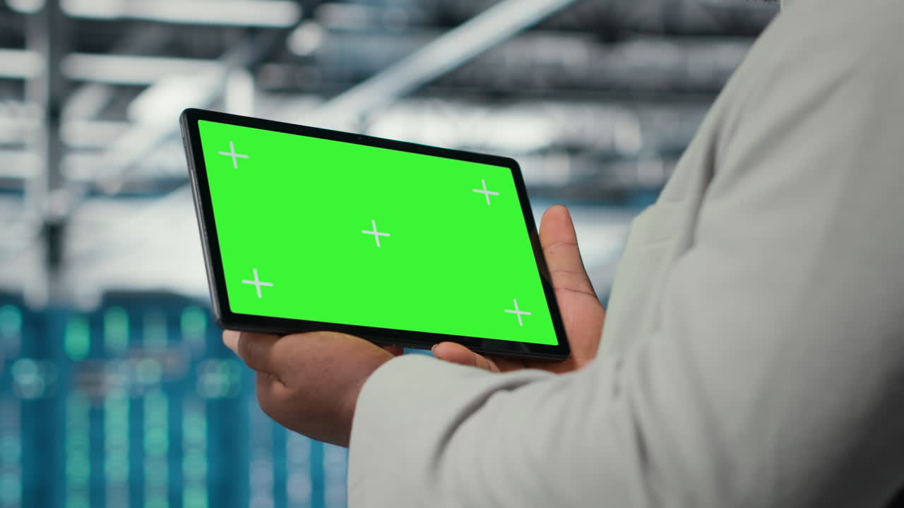 Data center IT expert uses mockup tablet, reviewing rigs performance, closeup