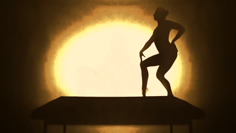 artist slim woman splitting in front of a theatre spotlight