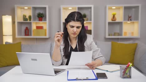 home office worker woman examining, analyzing documents.