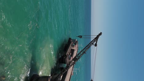 aerial vergara pier crane. vertical video, parallax shot