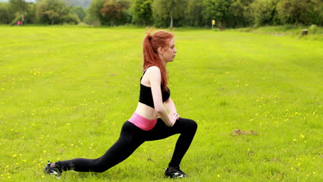 Fit-redhead-warming-up-on-the-grass