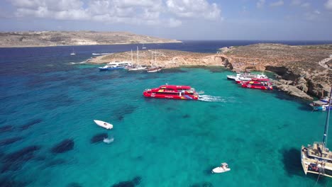 drone tracking tourist ferry leaving comino blue lagoon, malta