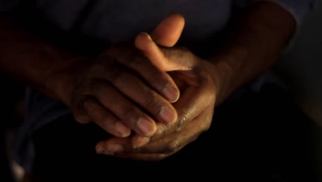 praying to god with hands together caribbean man praying with dark background stock video