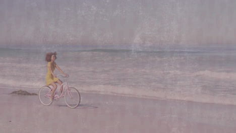 woman pedaling pink cruiser bicycle along beach shoreline, displaying floating health heart icon