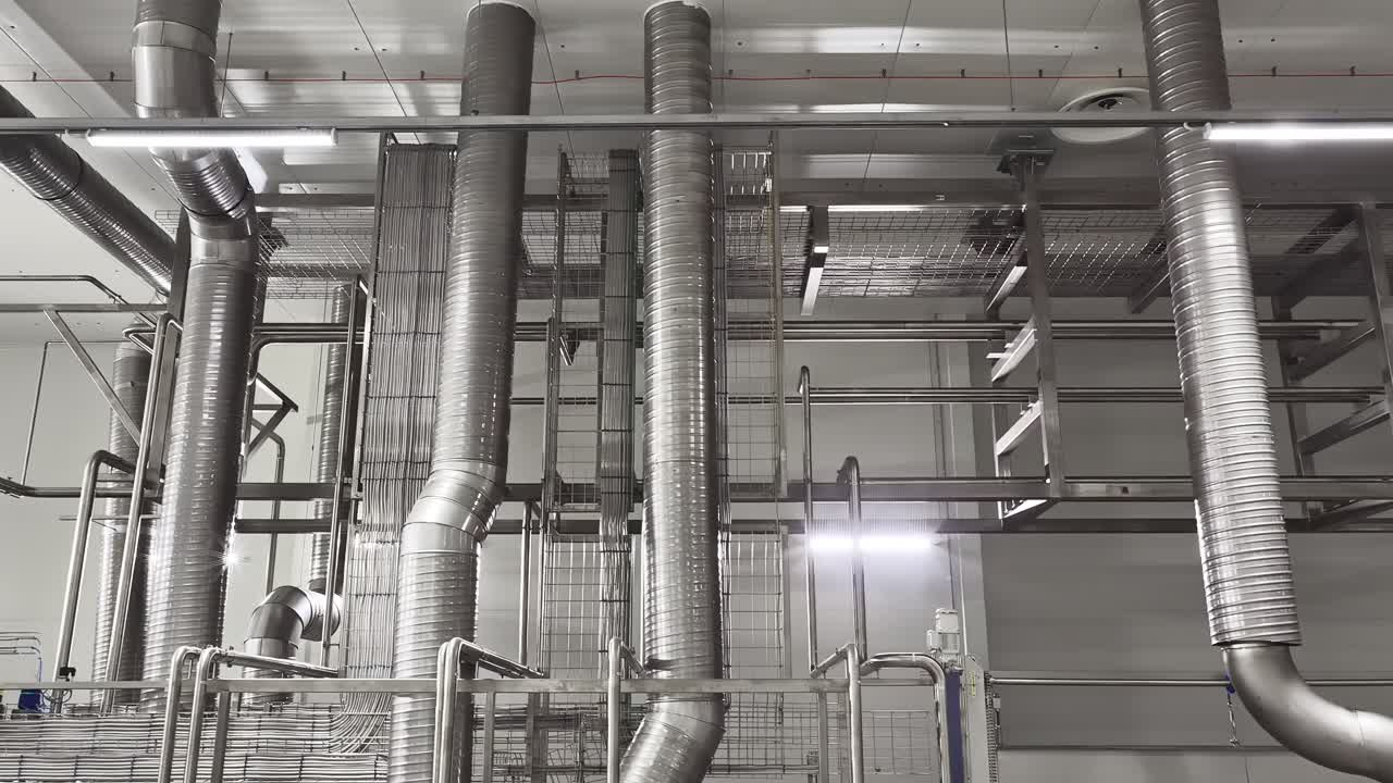 Industrial pipes and metal structures in a modern factory setting