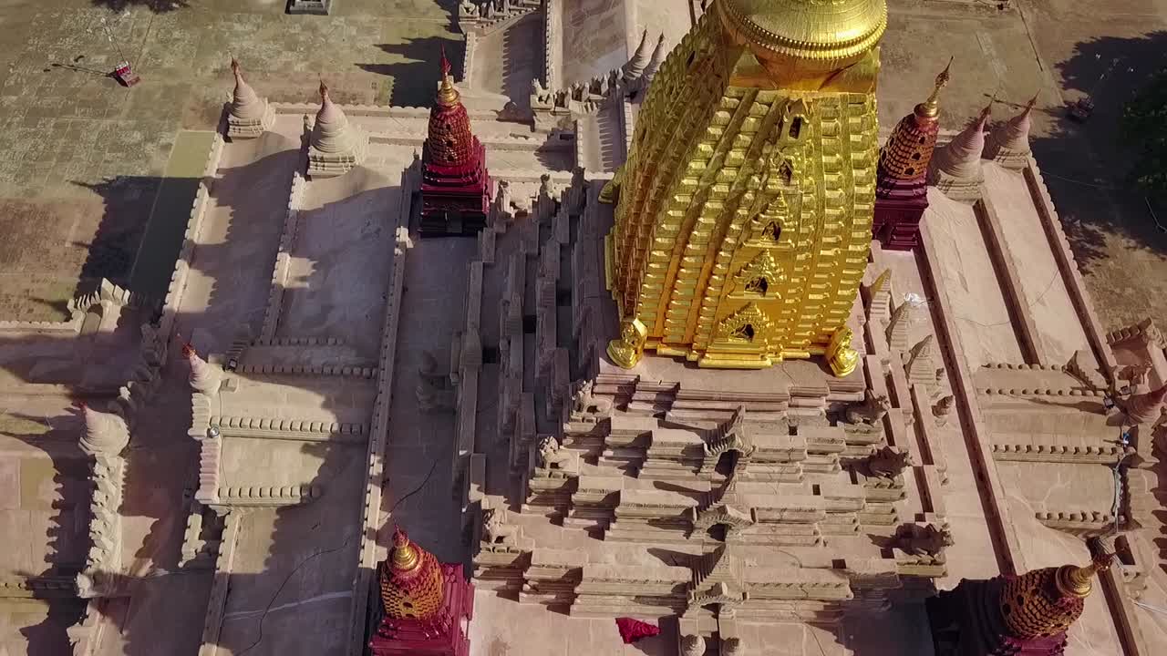 A captivating aerial point of interest shot around the White Temple and Ananda Temple in Bagan, Myanmar. Showcases the grandeur of these iconic ancient landmarks surrounded by lush landscapes.