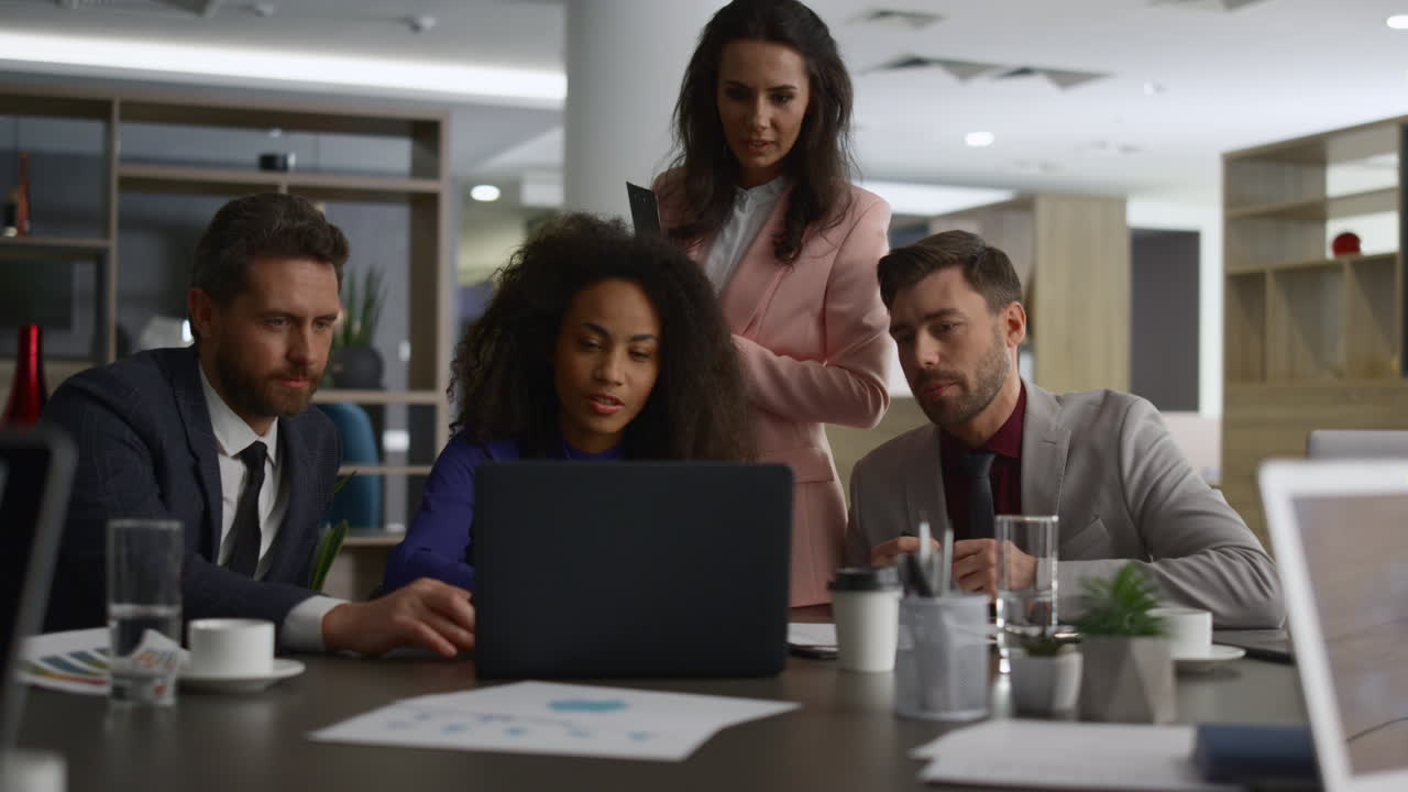Multiracial corporate group discuss finance plan. Business team searching laptop