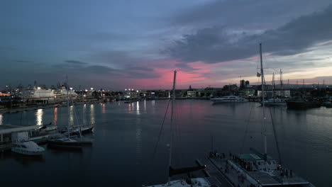 drone revealing boats docked in the yacht club during sunset