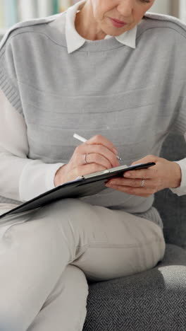 woman writing on clipboard