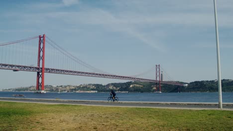 25 de abril bridge in lisbon with cyclist