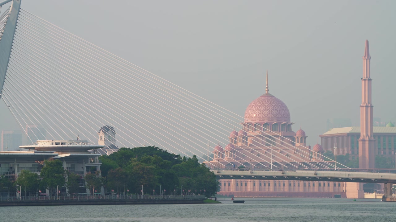 Puente Wawasan sobre el lago Putrajaya con la mezquita Putra al fondo, en Putrajaya, Malasia, durante el día