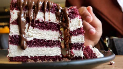 a slice of red velvet cake with chocolate drizzle