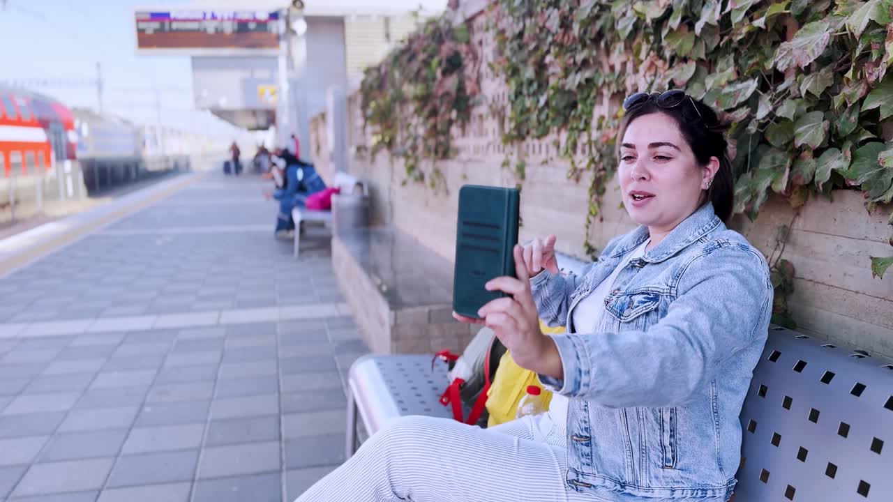 Woman on a Video Call Showing Her Surroundings at a Station