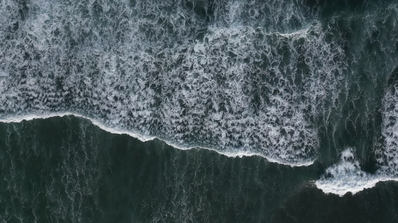Birds eye view of blue, tropical waves on the coast of Bali, Indonesia