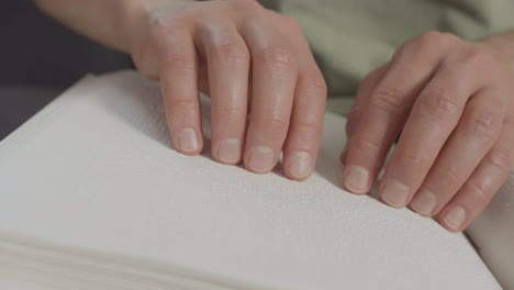 close up view of man hands touching a book