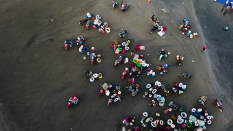 local fishing community on beach sorting and cleaning seafood