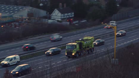 Toma-Aérea-De-Seguimiento-De-Inclinación-Panorámica-Del-Tráfico-En-Hora-Punta-En-La-Autopista-M20-En-Kent,-Reino-Unido