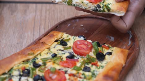 delicious turkish pide with cheese, tomatoes, olives and green peppers