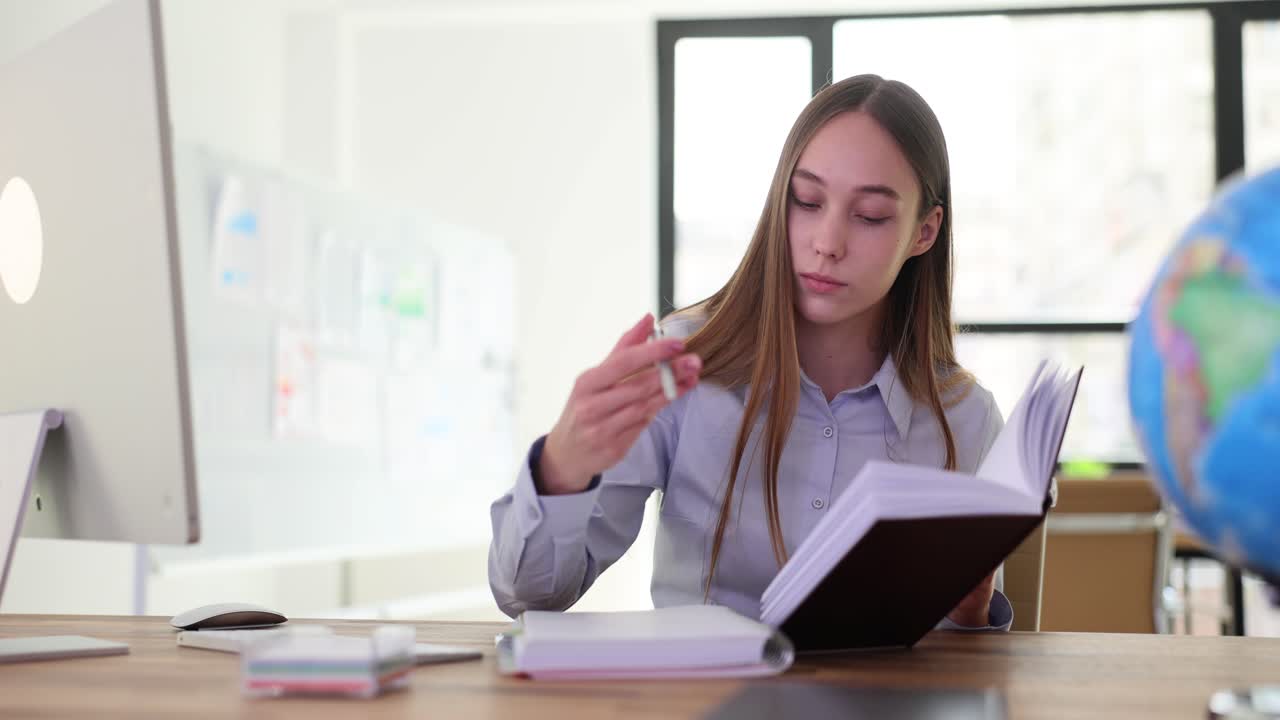 Young woman working at her desk in the office