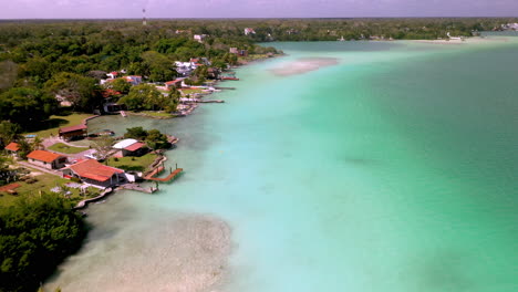 drone shot of coastal homes and clear water at baclar mexico