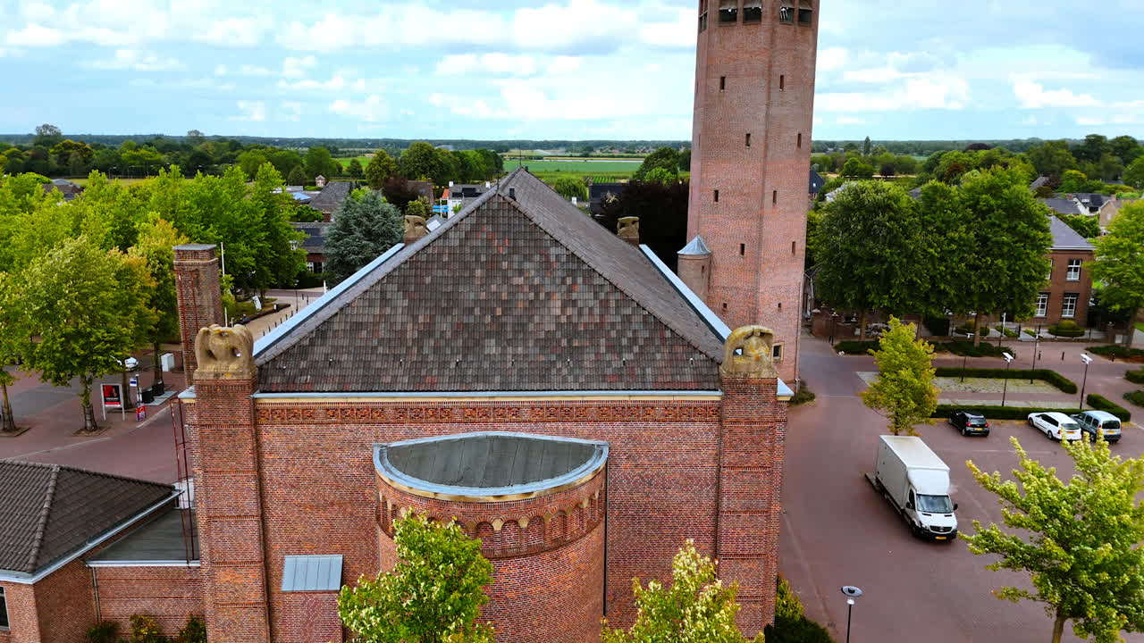 Rising above the Saint Lawrence Church in Vierlingsbeek, Netherlands. Aerial view on the residential houses at backdrop