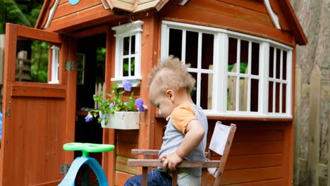 baby boy sitting on chair near play house 4k