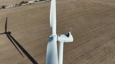 Drone-shot-inspecting-a-wind-turbine-that-is-not-moving-or-working