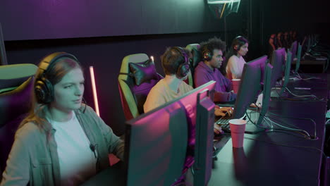 team of four cybersport gamers playing video games in a gaming club 4