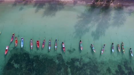 Tilt-camera-down-from-horizon-to-empty-longtail-boats-and-coral-reef