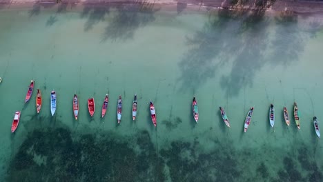tilt camera down from horizon to empty longtail boats and coral reef