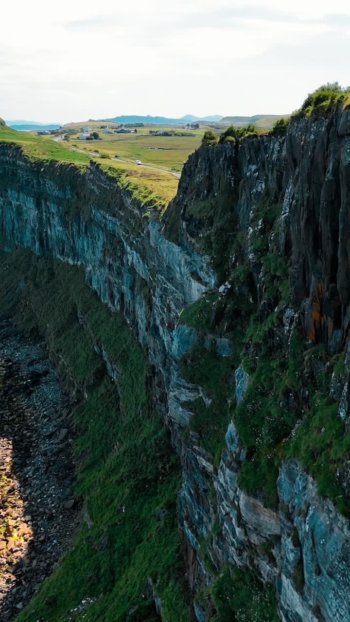 Stunning aerial view of rugged cliffs along the coastline of Scotland