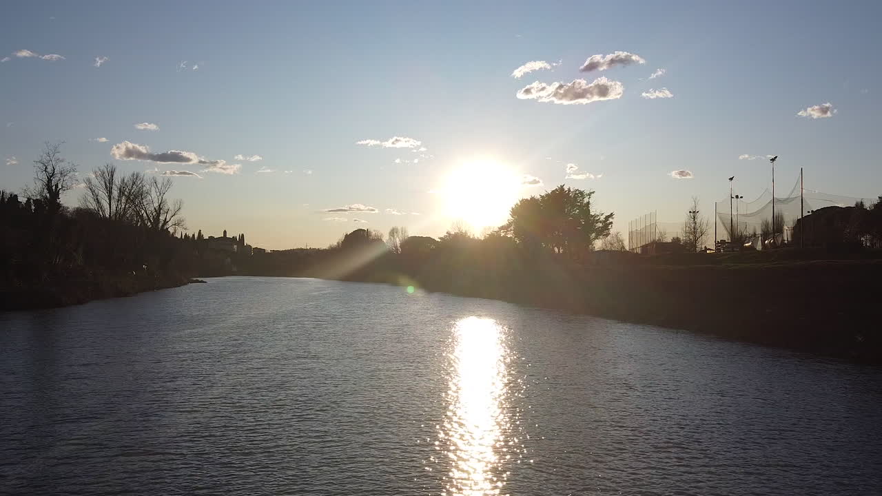 Sunset drone flies above the Arno river. Girone small town near Fiesole Florence, in the Tuscany region of Italy. December 2019