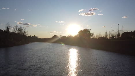 sunset drone flies above the arno river. girone small town near fiesole florence, in the tuscany region of italy. december 2019