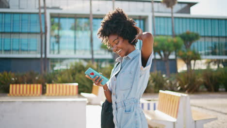 woman using phone in a city park