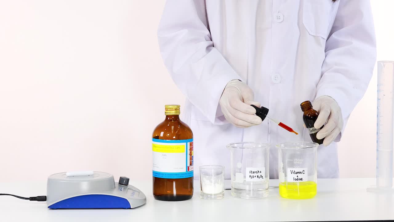 Scientist performing iodine clock reaction experiment with laboratory equipment