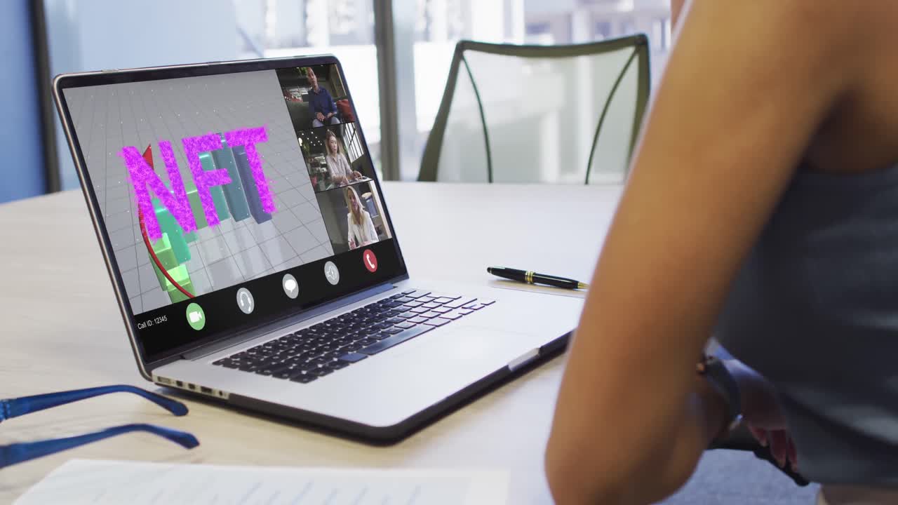 Video of biracial woman having nft video call on laptop with diverse coworkers