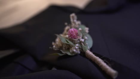 wedding decorative details of a rose in man's suit, macro