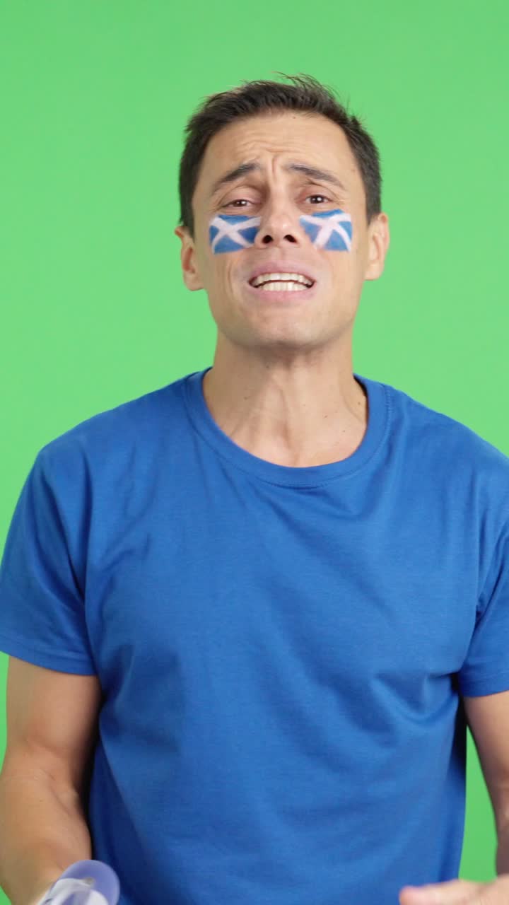 Man cheering for Scotland during a match that is lost