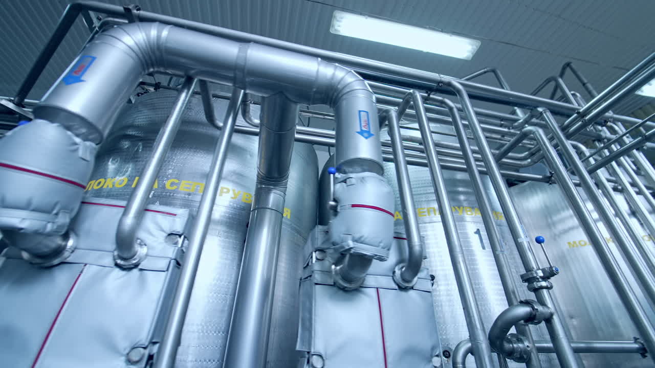 Industrial dairy production factory. Metallic stainless steel pipes in modern dairy plant