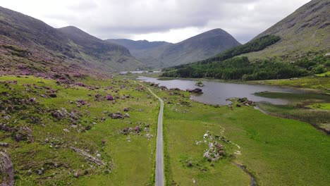 Beautiful-valley,-an-aerial-footage-liftoff-with-the-view-over-road,-lake,-river-and-surrounding-mountains