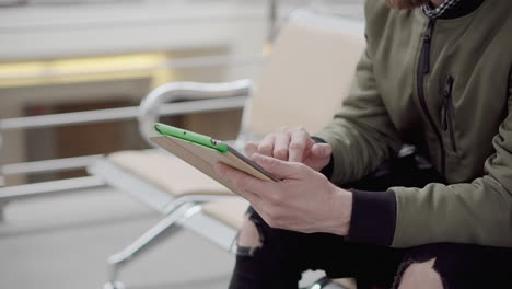 man using tablet in airport