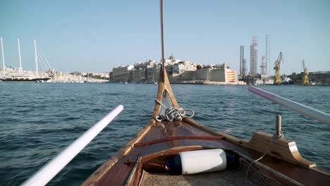 Point-of-view-from-a-Gondola-crossing-the-harbour-from-Valletta,-Malta