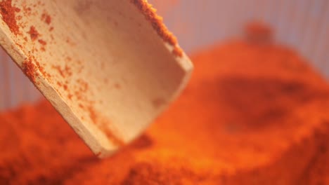 wooden spoon full of chili powder