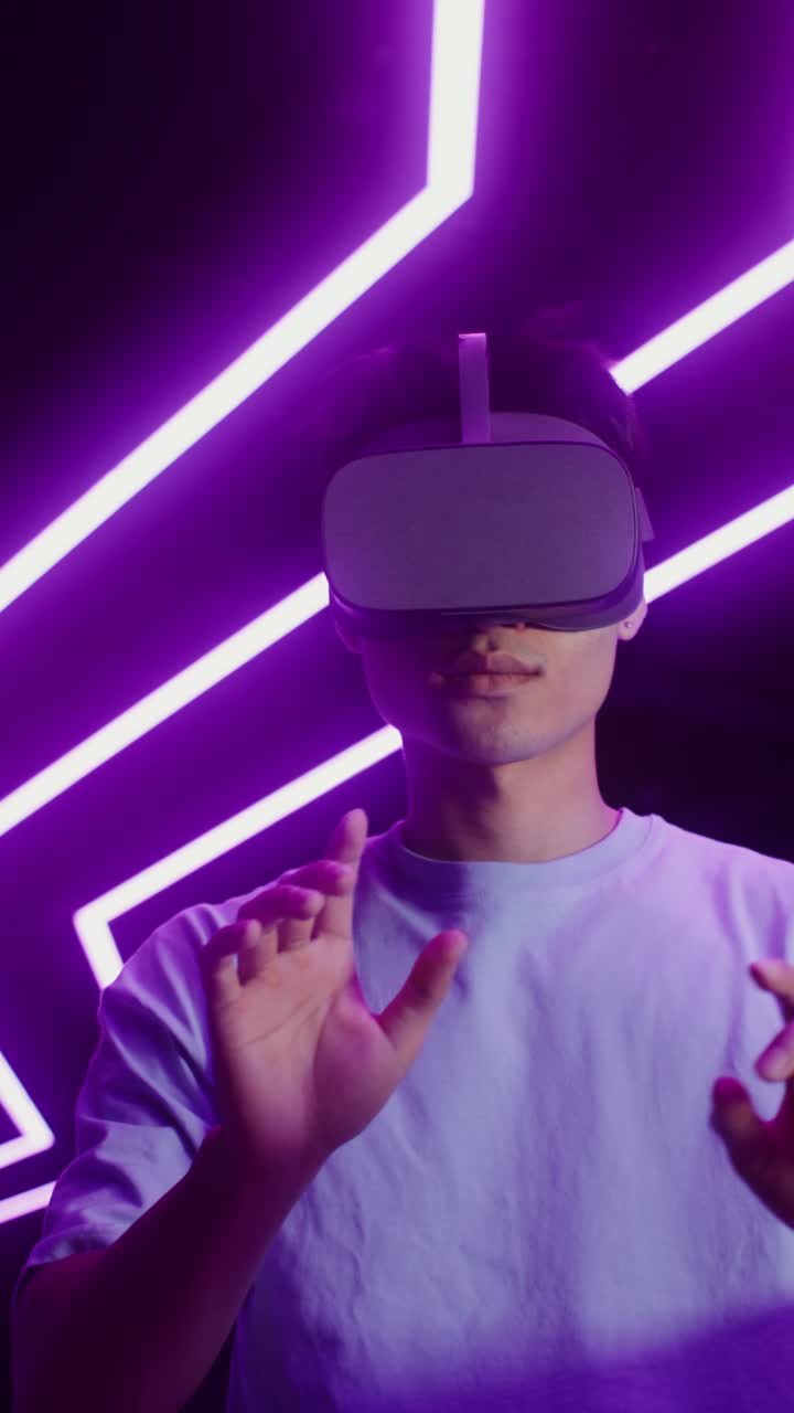 Man wearing VR headset in a neon environment