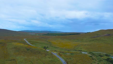 a 4k drone push forward over barren countryside in connemara