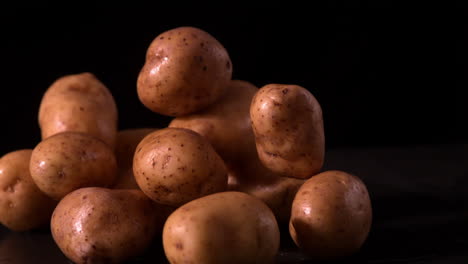 potato falling on pile of potatoes